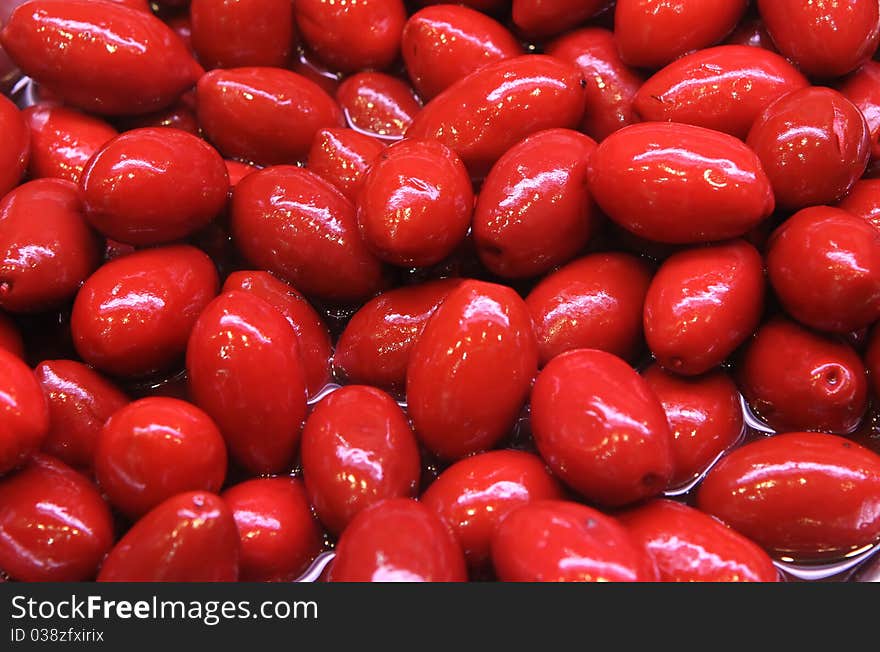 Red olives close up in sharp marinade