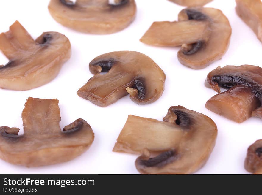 Close-up of fried brown mushrooms (champignons) isolated on white background. Close-up of fried brown mushrooms (champignons) isolated on white background