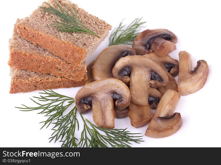 Fried mushrooms (champignons) and rye bread garnished with dill isolated on white background. Fried mushrooms (champignons) and rye bread garnished with dill isolated on white background