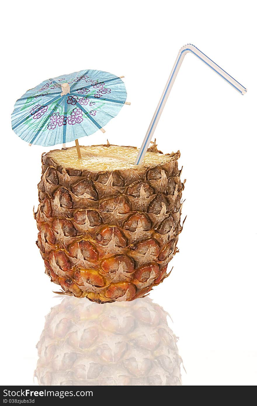 Half of a pineapple is a cocktail with a tube and umbrella. Half of a pineapple is a cocktail with a tube and umbrella.