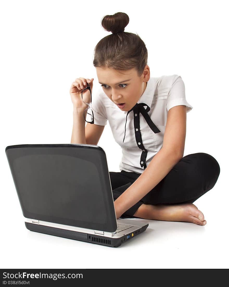 Beautiful girl sitting on the floor and works on a laptop keep the glasses in her hand isolated on white background Student Series