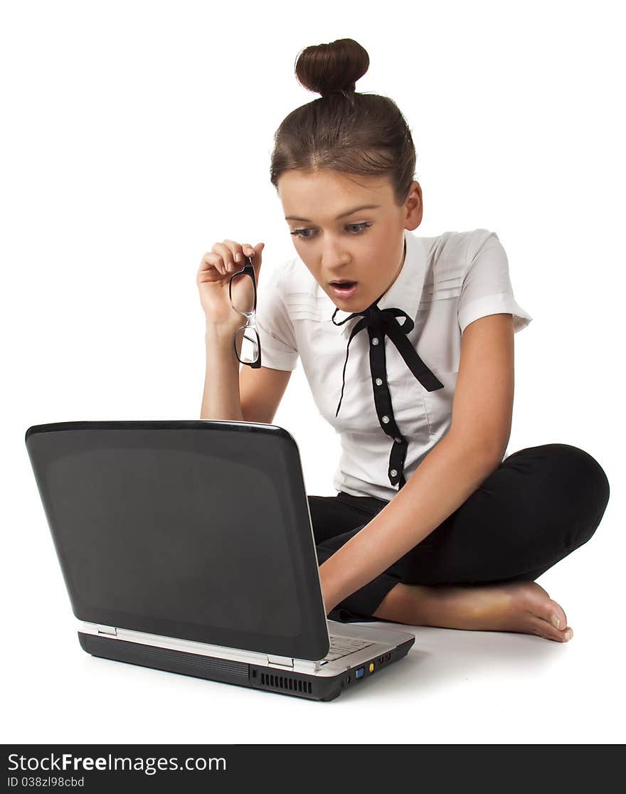 Beautiful girl sitting on the floor and works on a laptop keep the glasses in her hand isolated on white background Student Series