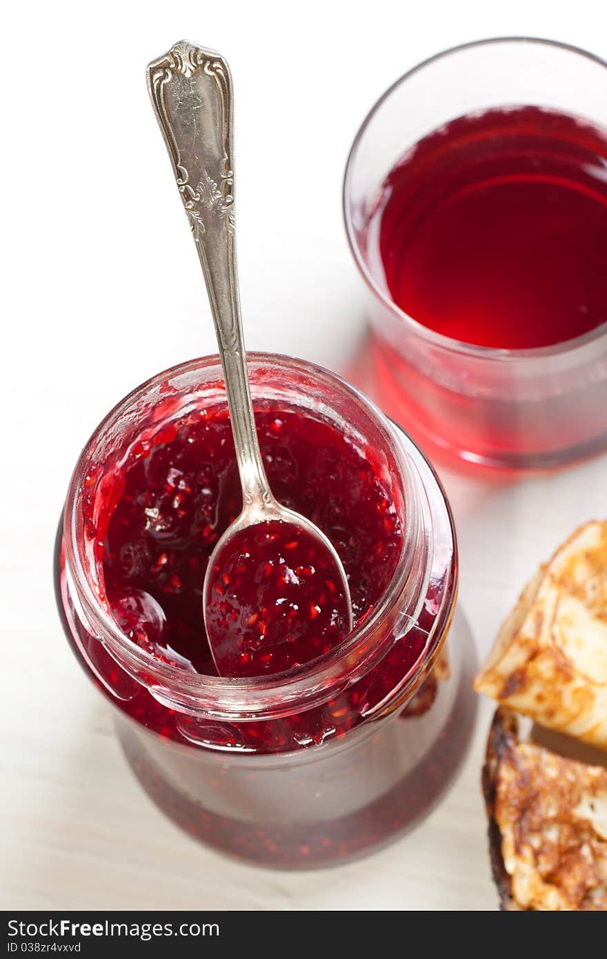 Breakfast with pancakes and strawberry jam