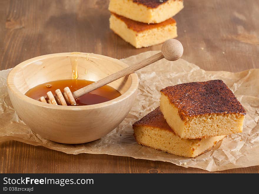 Homemade honey cakes with wooden bowl of honey