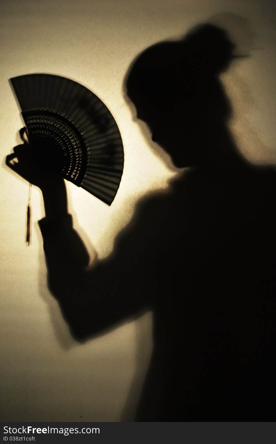 Shadow of a girl holding chinese fan. Shadow of a girl holding chinese fan