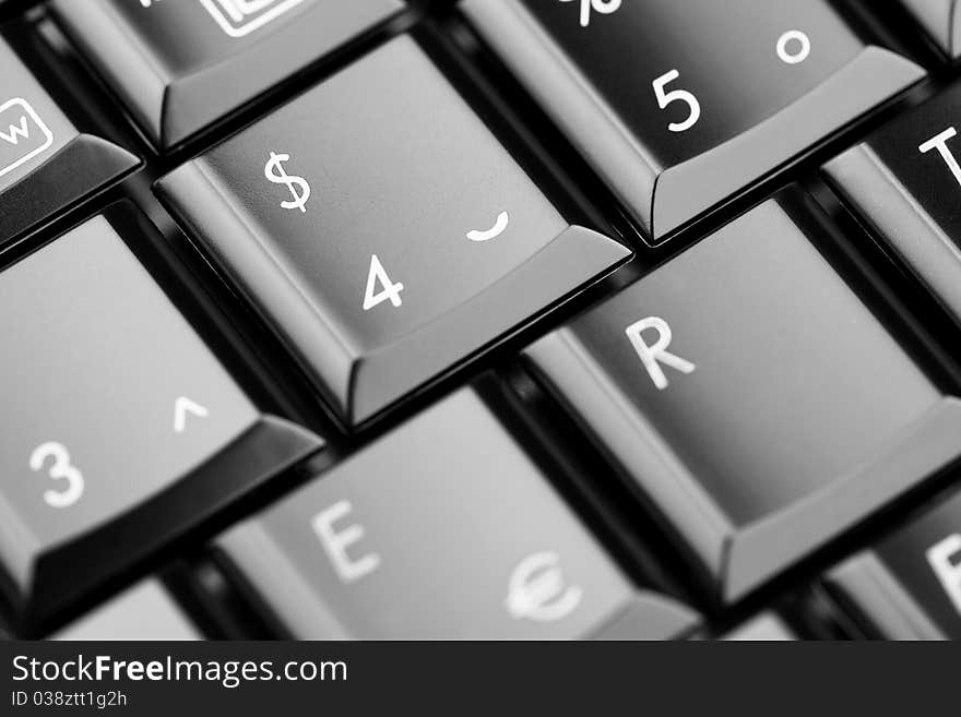 Closeup of laptop keyboard. Emphasis on »dollar« button. Shallow depth of field. Closeup of laptop keyboard. Emphasis on »dollar« button. Shallow depth of field