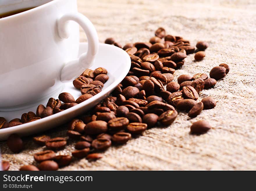 Coffee cup and grain on a fabric. Still-life