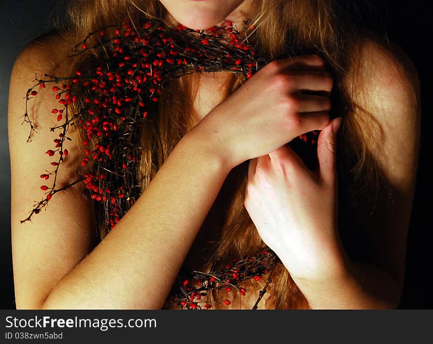 Girl holding red thorne in her hands. Girl holding red thorne in her hands