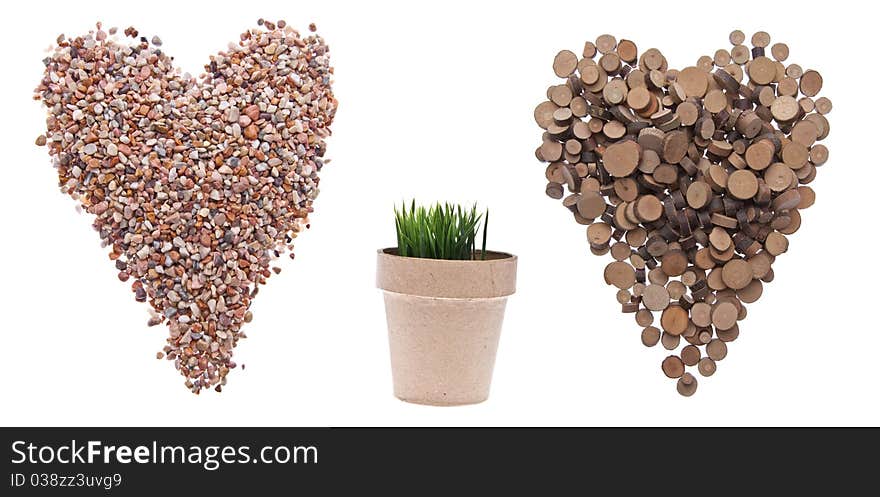 Environment Concept with Hearts of Rock and Tree and a Pot with Green Grass Growing Isolated on White. Environment Concept with Hearts of Rock and Tree and a Pot with Green Grass Growing Isolated on White.