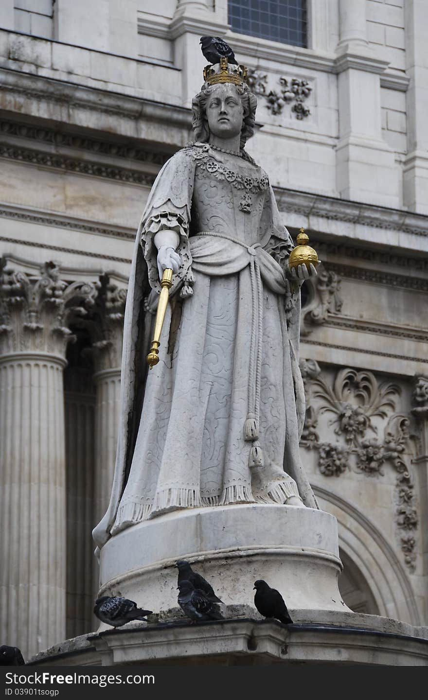 Pigeons perching on top of a statue of Queen Anne with St. Paul's Cathedral in the background. Pigeons perching on top of a statue of Queen Anne with St. Paul's Cathedral in the background.