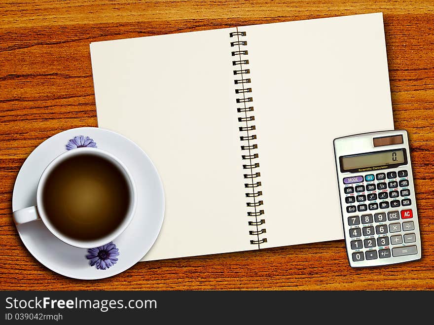 White cup of coffee and calculator on blank page notebook on wood table background