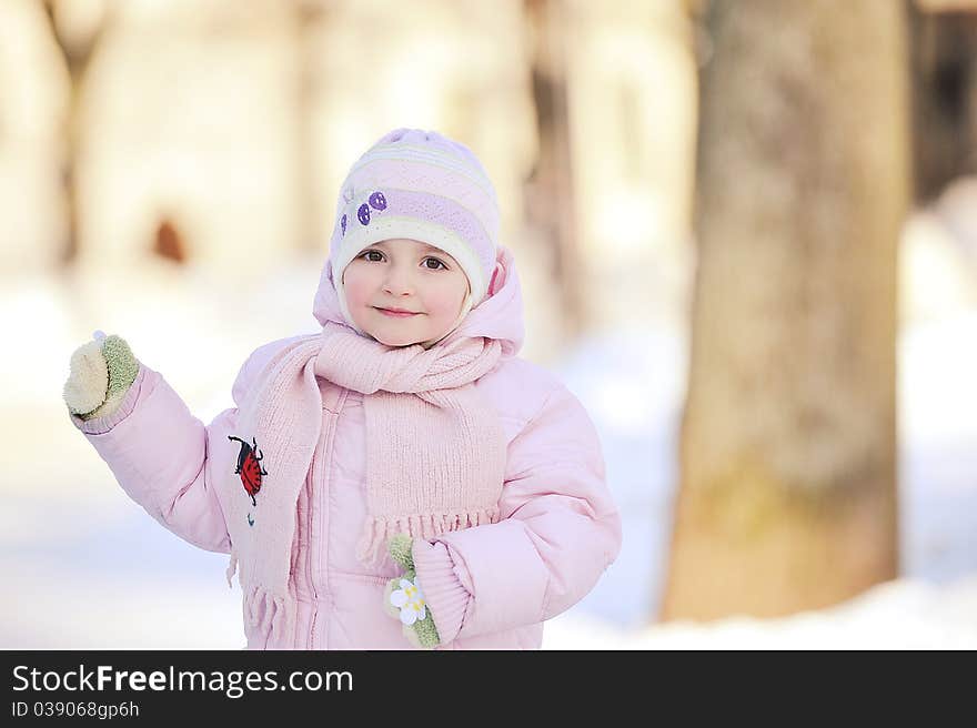 Small beautiful girl playing in park.  winter day