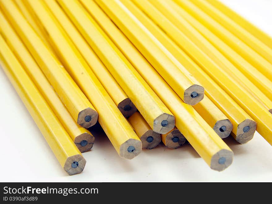 Yellow pencils arranged against a white background.