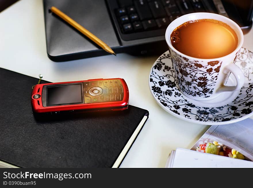 Workplace with coffee, cellphone and notebook. Workplace with coffee, cellphone and notebook