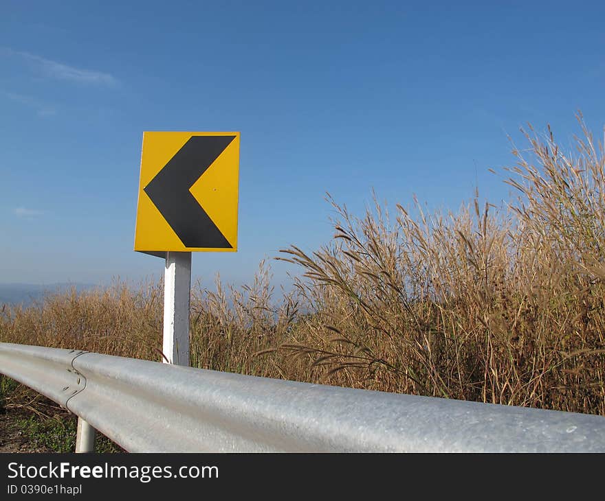 Yellow signboard an blue on the mountain