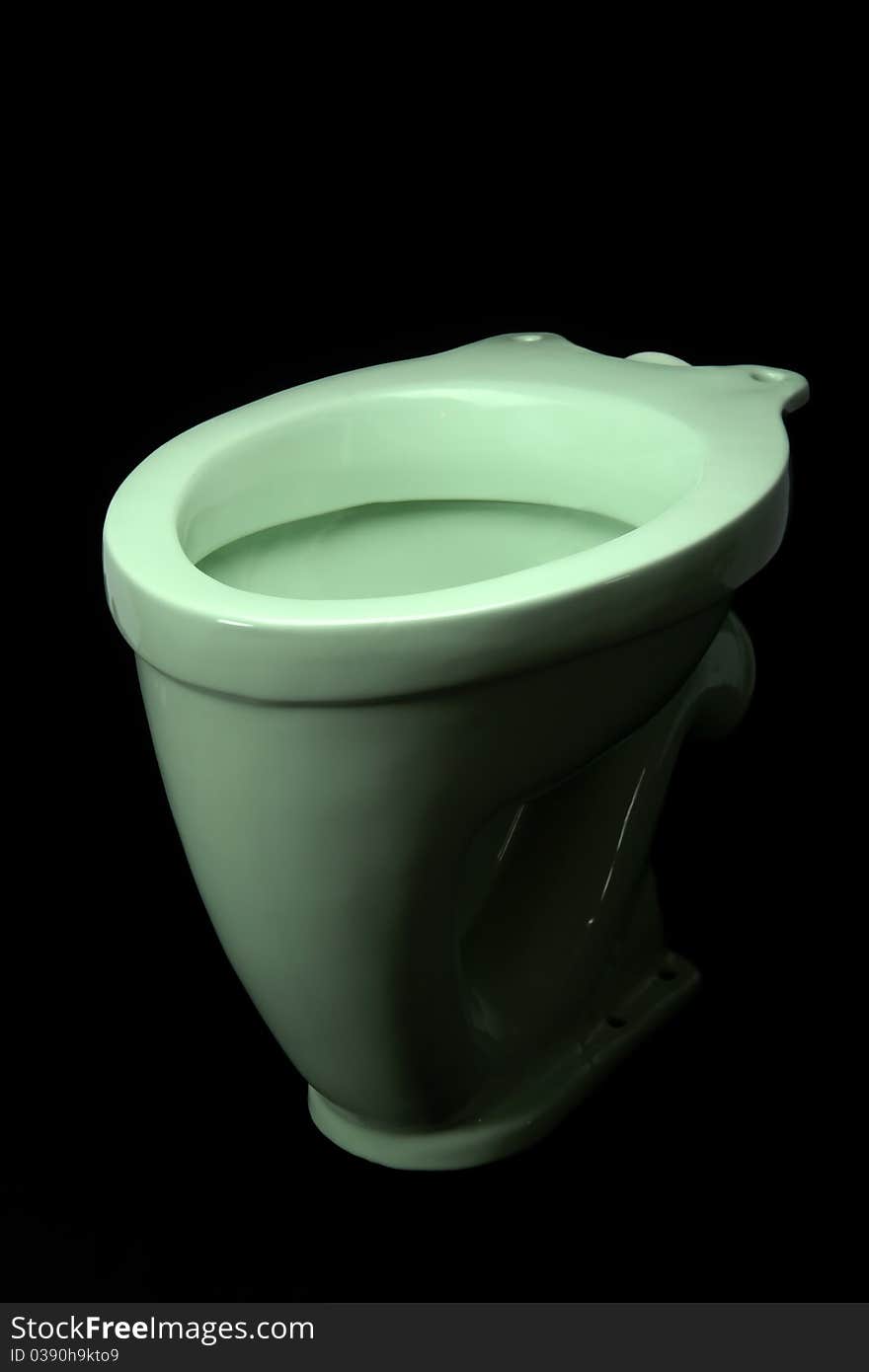 The light green toilet bowl, isolated on black background