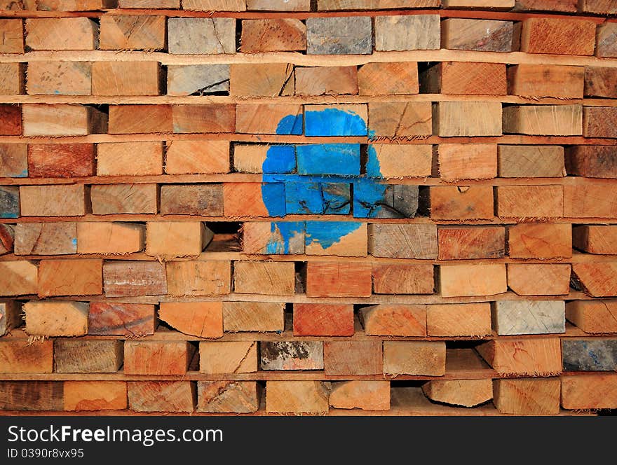 Stacked pile of wooden timber.