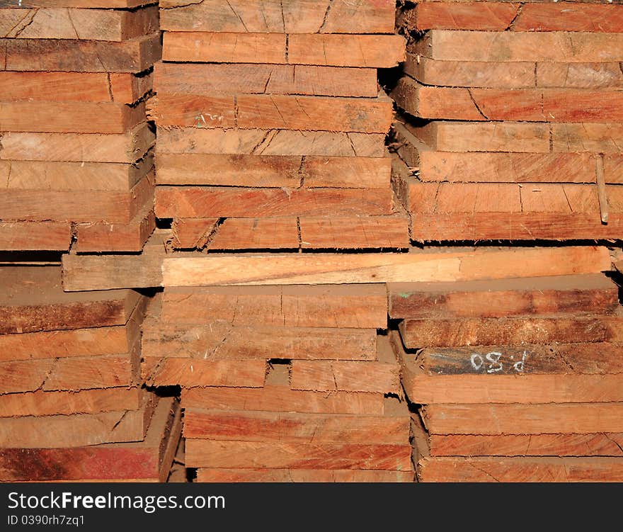 Stacked pile of wooden timber. Stacked pile of wooden timber.