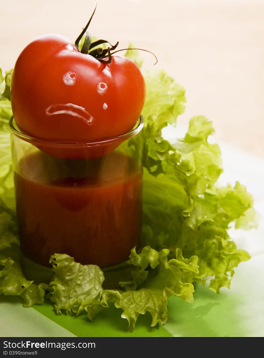 Red tomato on glass with leaf lettuce. When tomatos cry. Red tomato on glass with leaf lettuce. When tomatos cry...