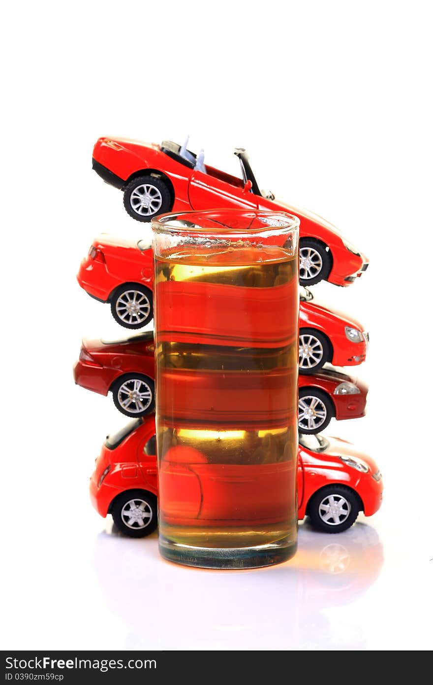 Glass full of beerl with heap of cars  isolated on white background. Glass full of beerl with heap of cars  isolated on white background.