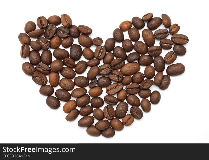 Heart made of roasted coffee beans on white background