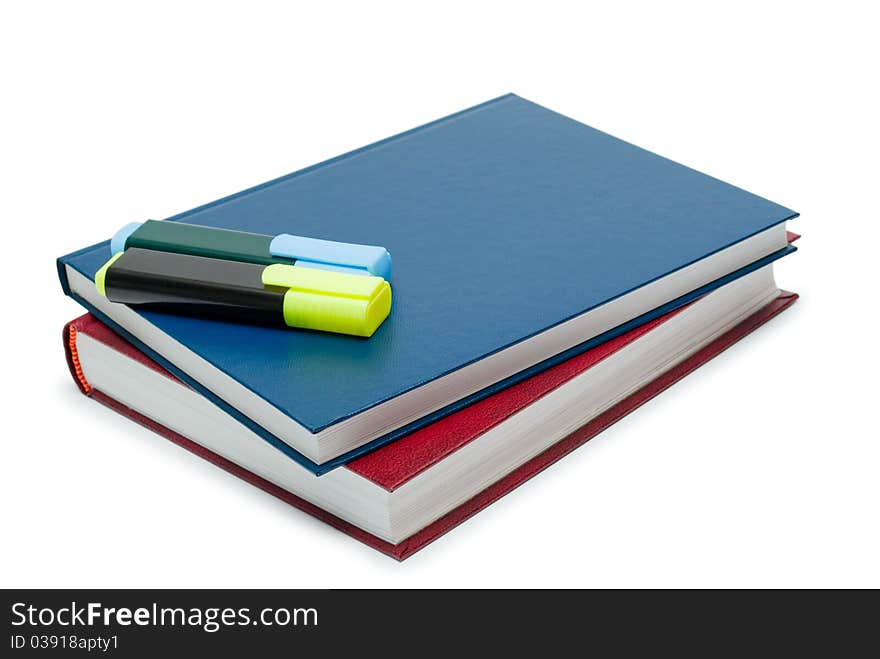 Two books and two markers on a white background