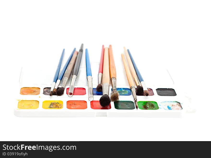 Watercolors with paint brushes isolated on a white background. Watercolors with paint brushes isolated on a white background.