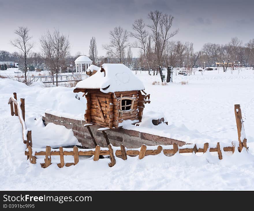 Wooden house covered with snow