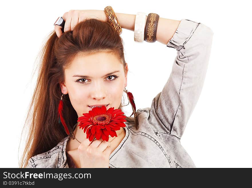 Beautiful girl with red flower near lips on white background