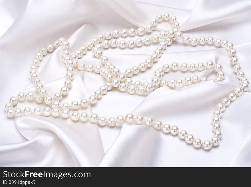 Jewels on white satin as a background