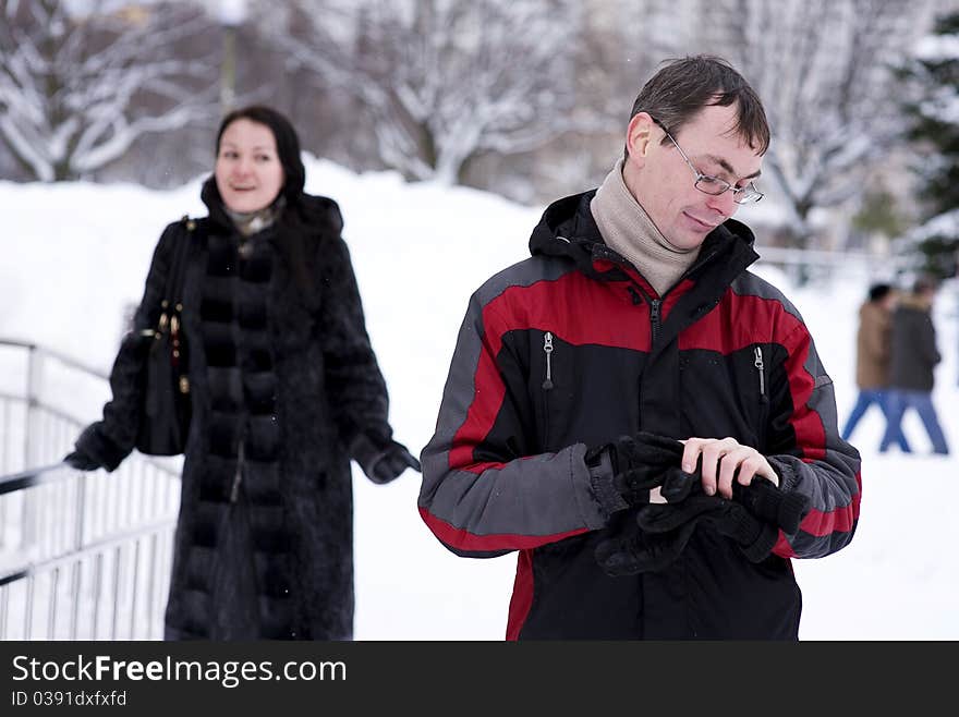 Man waiting the woman and looking watch in winter time. Man waiting the woman and looking watch in winter time