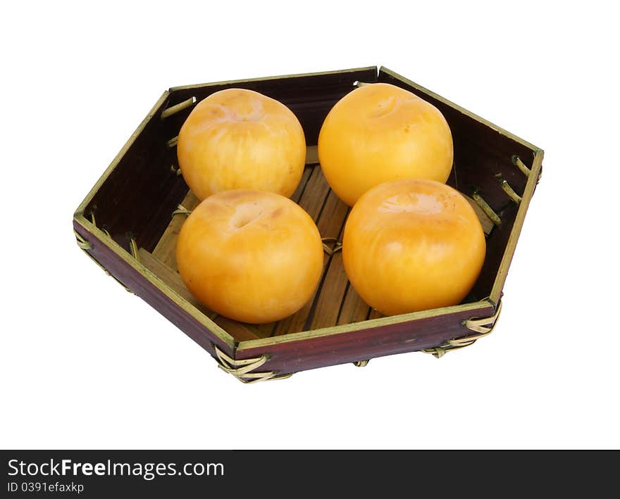 Yellow plums on a dark blue plate, isolated on a white background