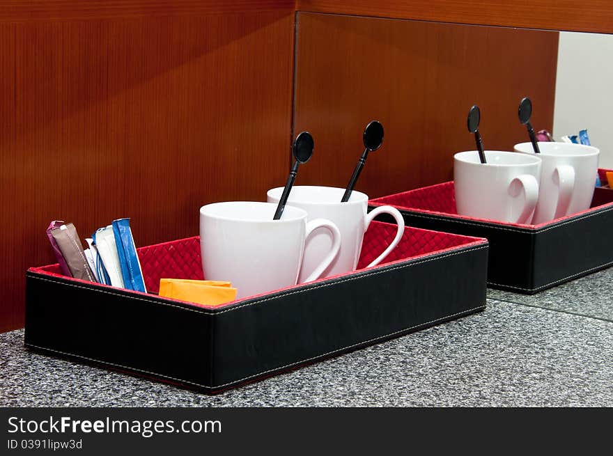 Cups, tea and coffee at the hotel room with reflection of mirror. Cups, tea and coffee at the hotel room with reflection of mirror.