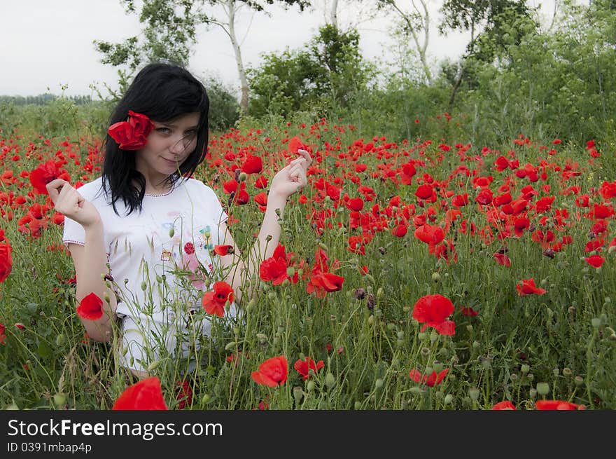 Beautiful Black Hair Girl in poppies filed. Beautiful Black Hair Girl in poppies filed