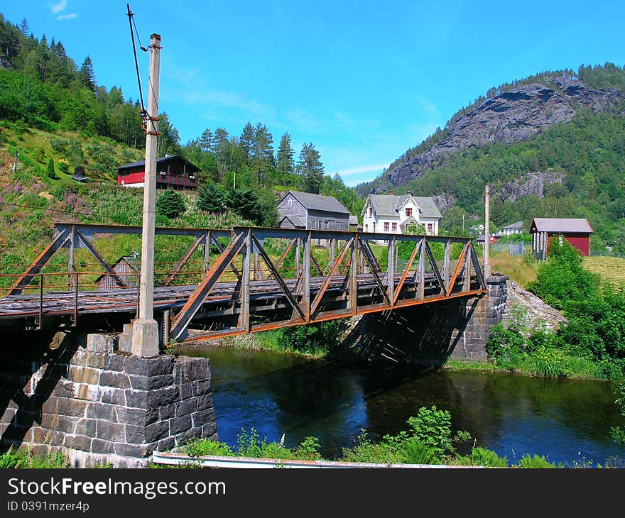 Old rusty iron bridge across the river. Old rusty iron bridge across the river