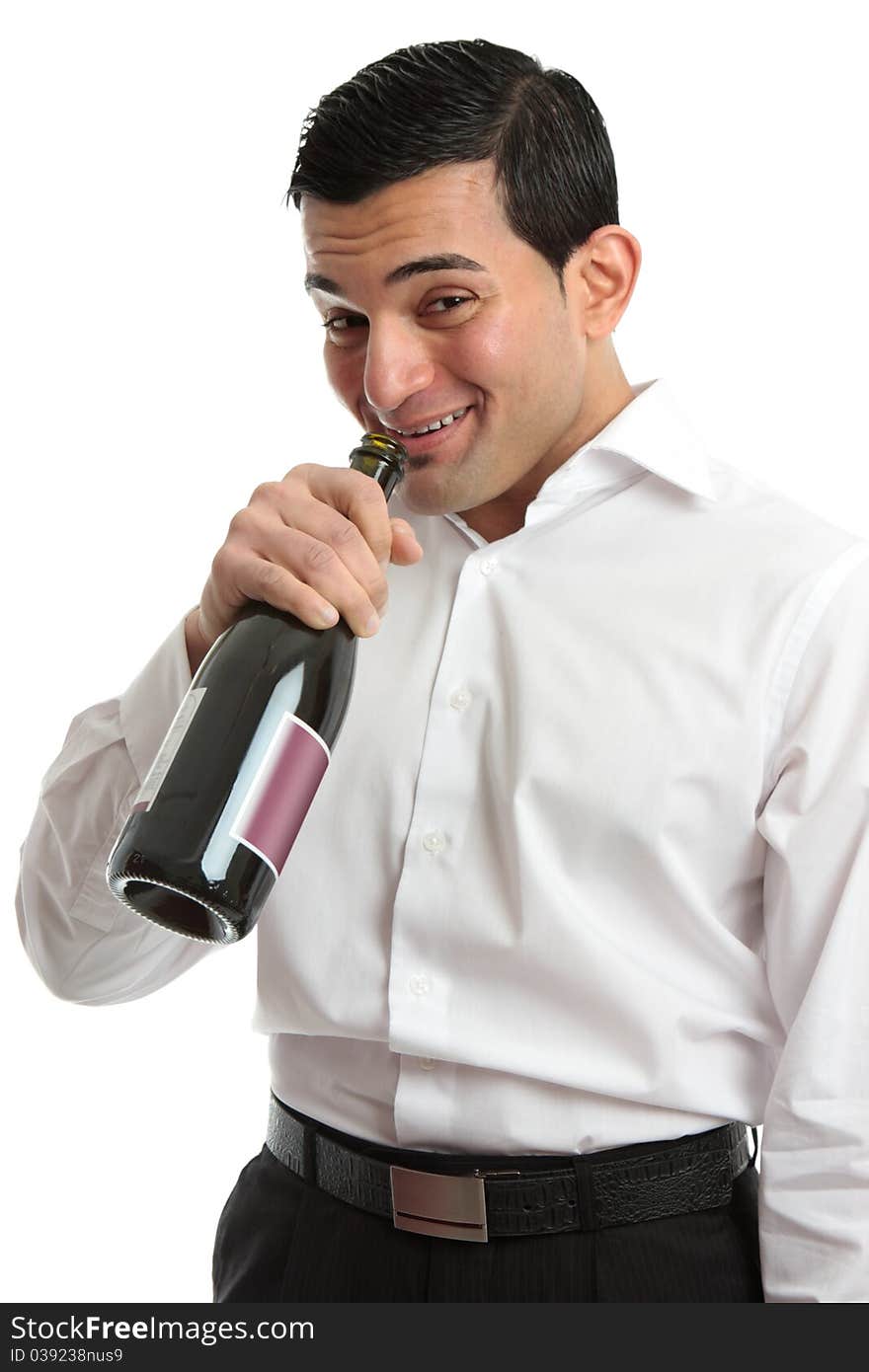 A tipsy or drunk man party goer drinking directly from a wine bottle. A tipsy or drunk man party goer drinking directly from a wine bottle