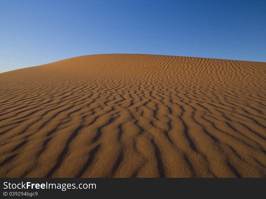 Colorful sand dunes in the morning sunlight