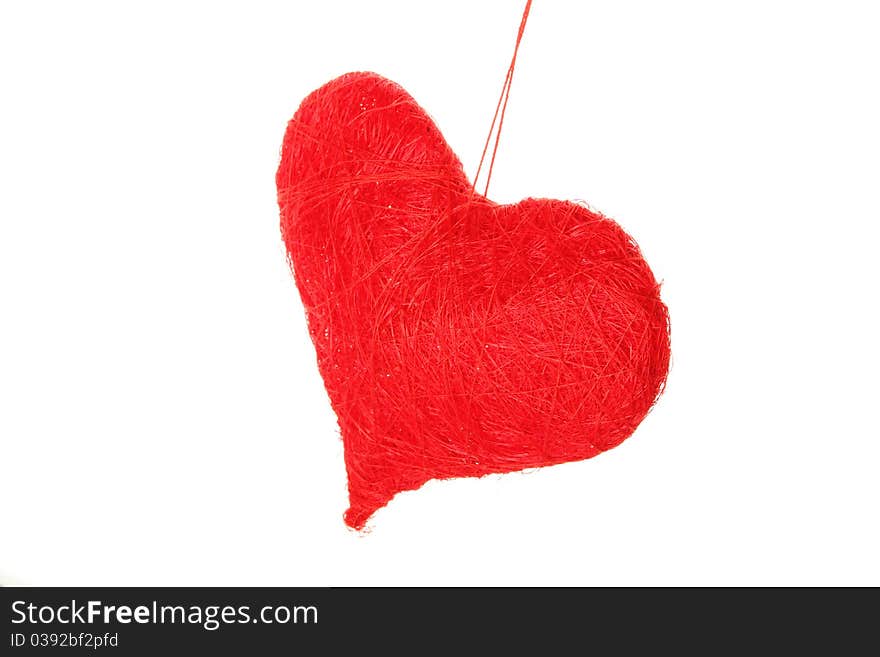 Red heart of the thread isolated on white background