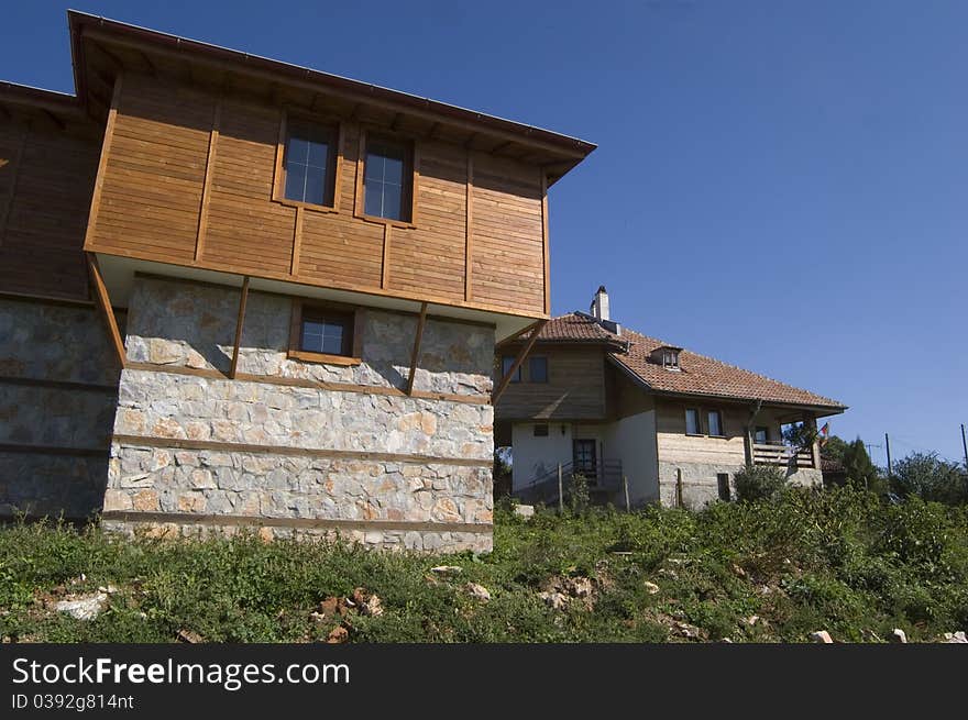 Bulgarian Traditional wooden house on mountain side in rural village in Bulgaria built of stone and wood in the old style