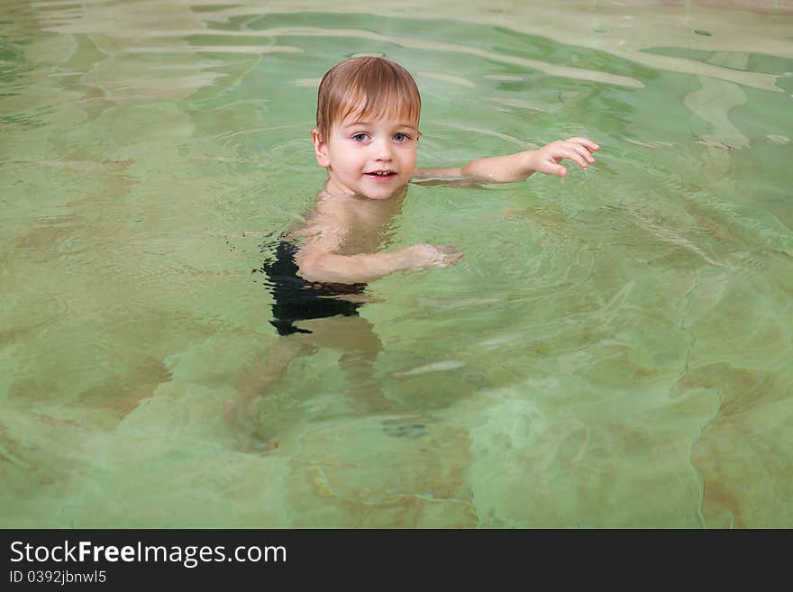 Little happy boy swimming in pool. Little happy boy swimming in pool