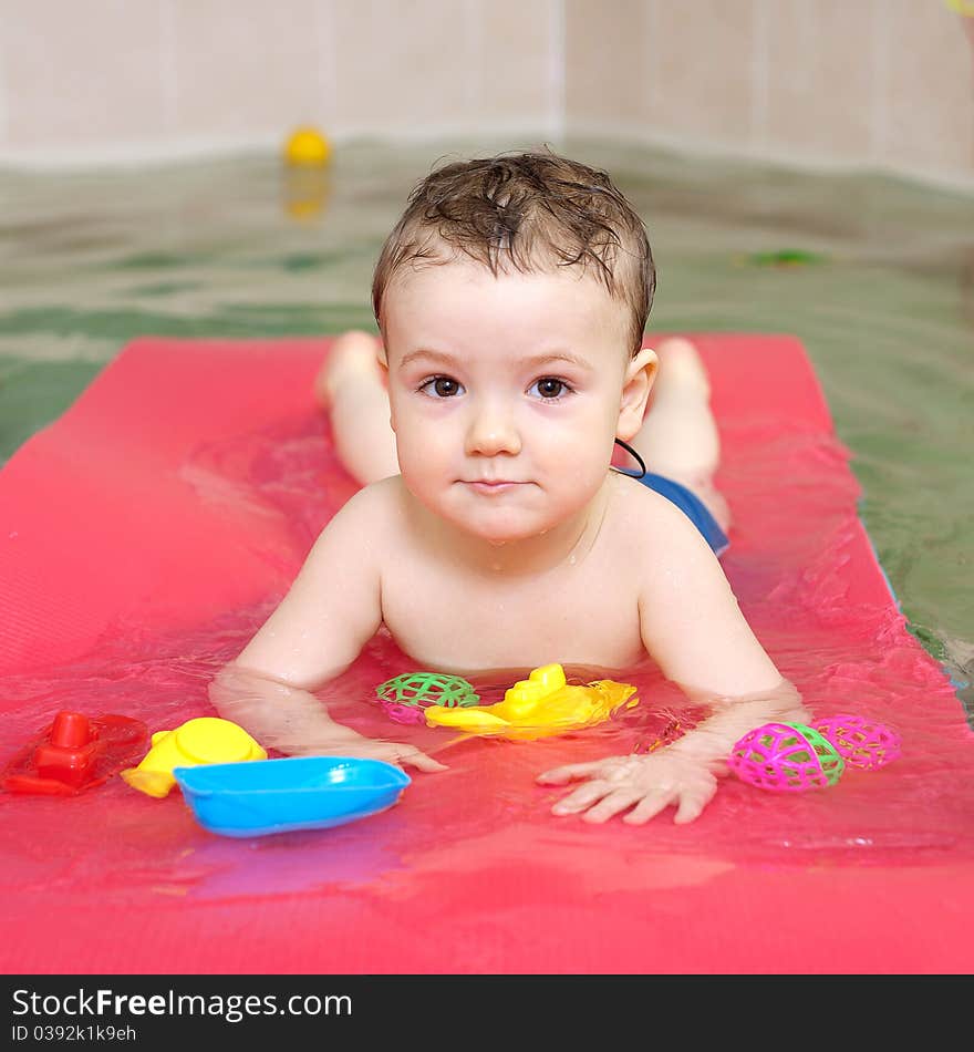 Little happy boy swimming in pool. Little happy boy swimming in pool