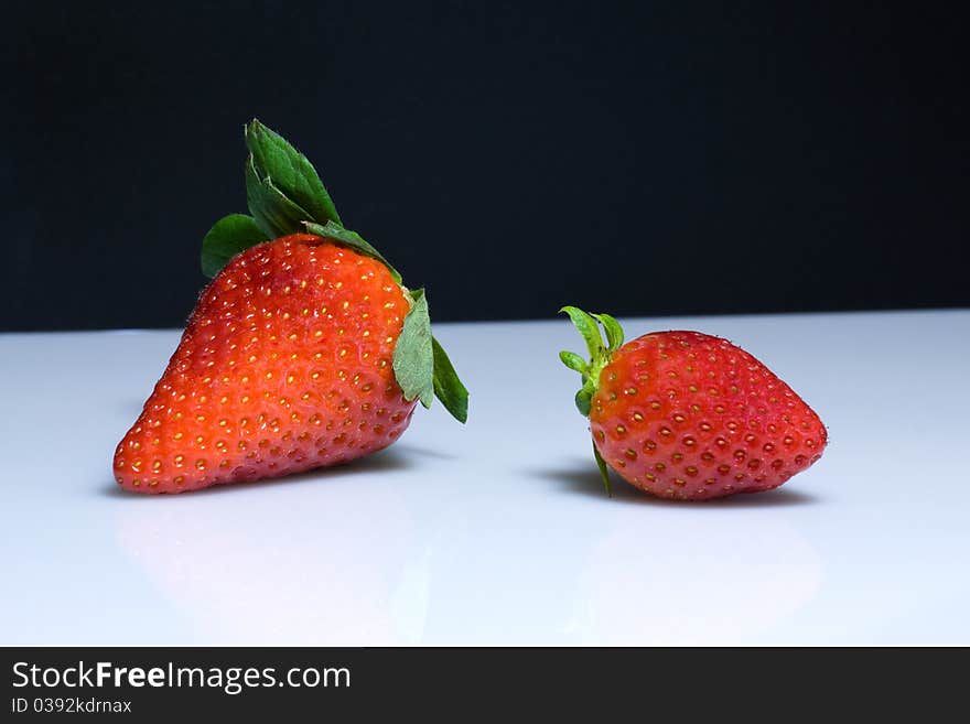 Red strawberries on black and white background