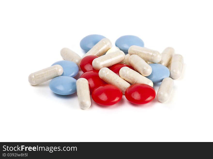 Capsules and pills on white background