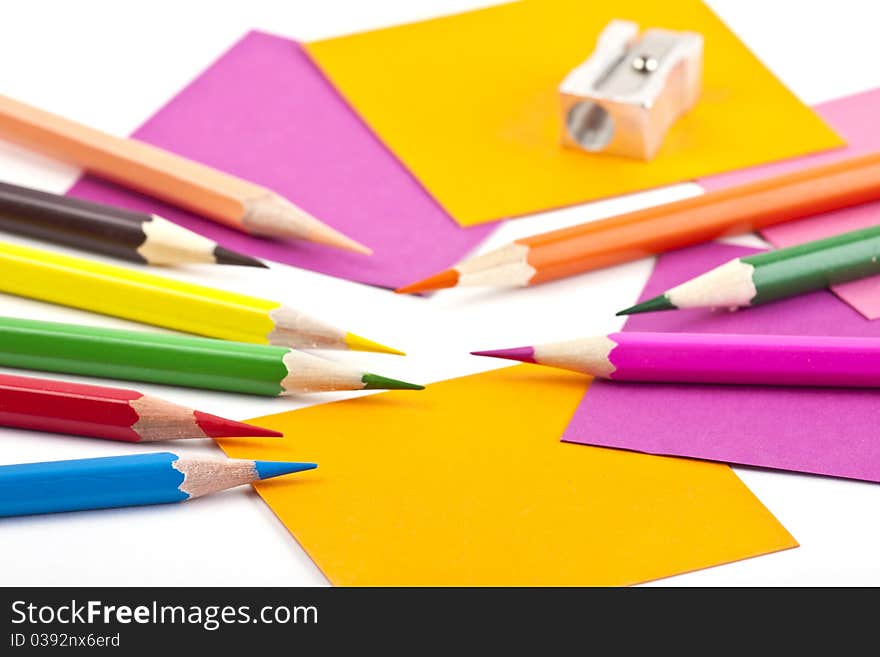 Colorful pencils and note papers on white