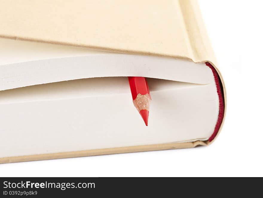 Red pencil on closed book isolated