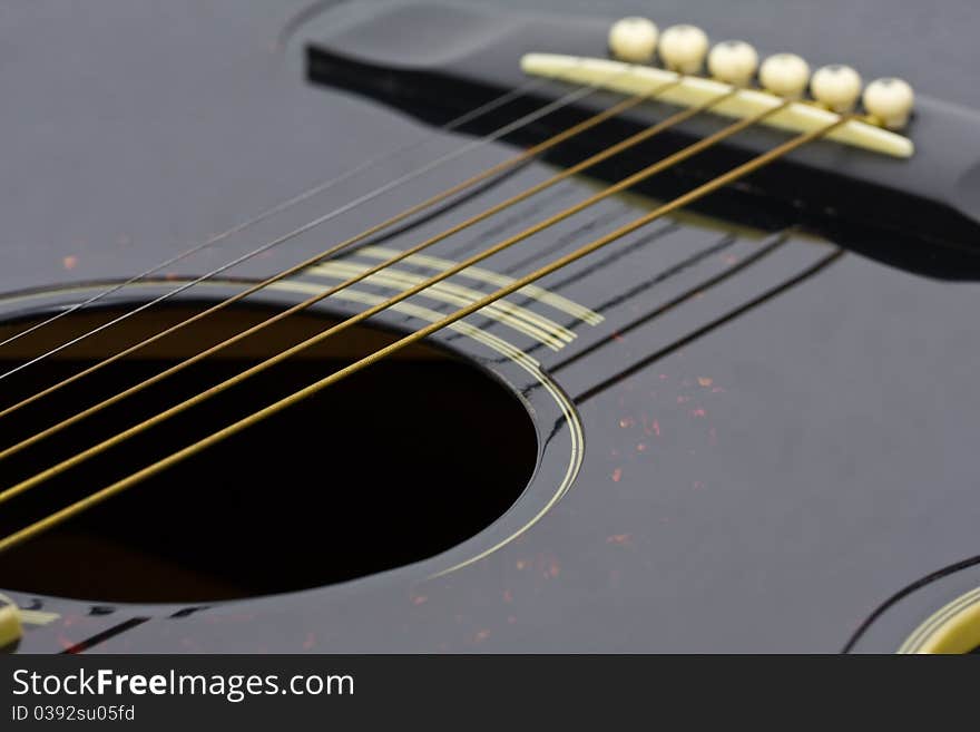 Close-up of strings of a folk guitar