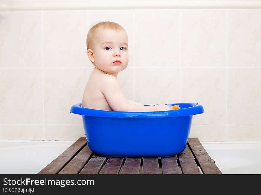 Little boy sitting in bath