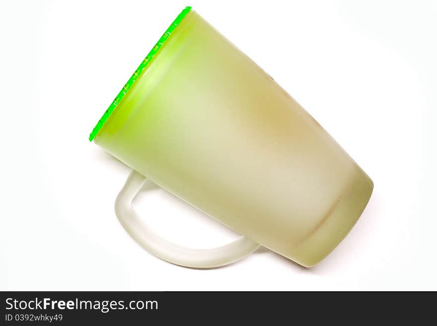 Glass of water on a white background with a green cap