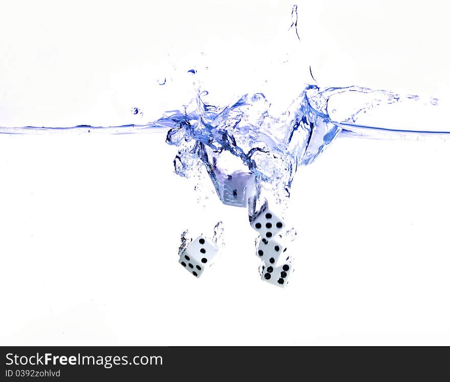 Five dice splash in bluish water