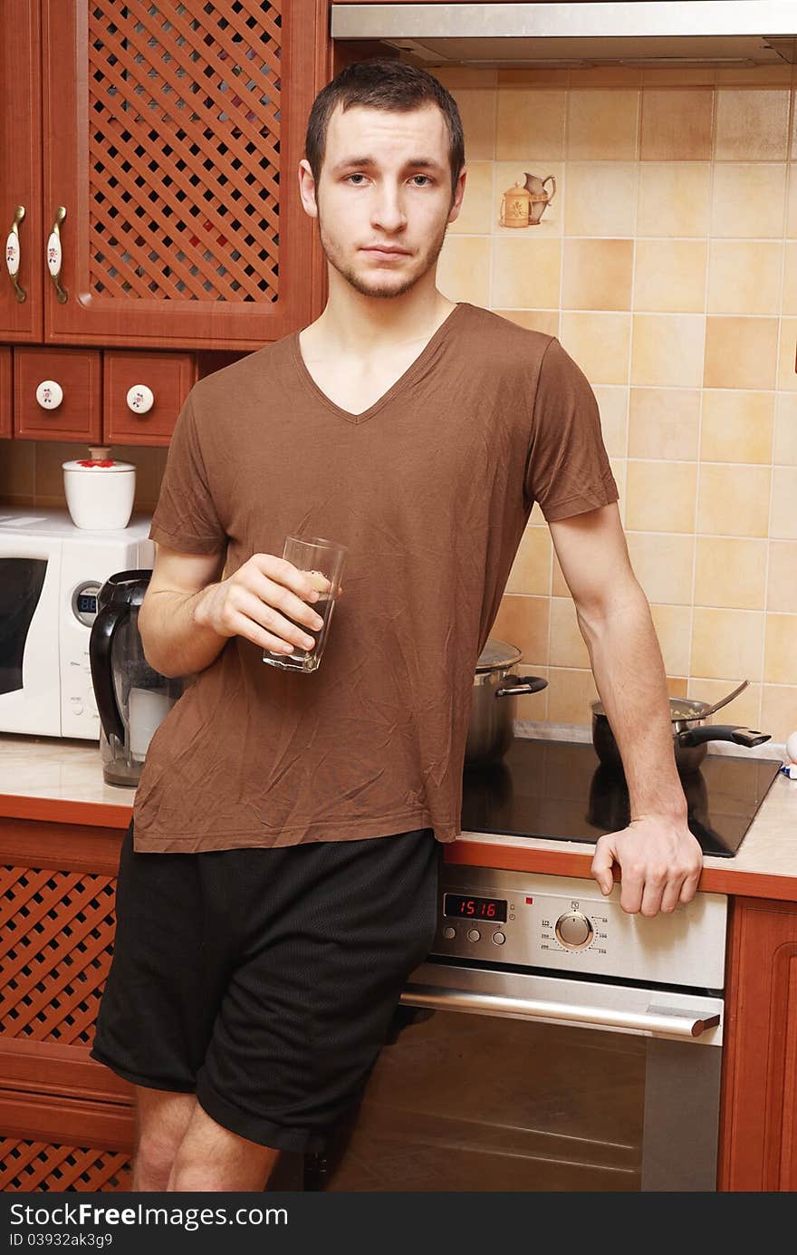 Guy In The Kitchen With Glass Of Water